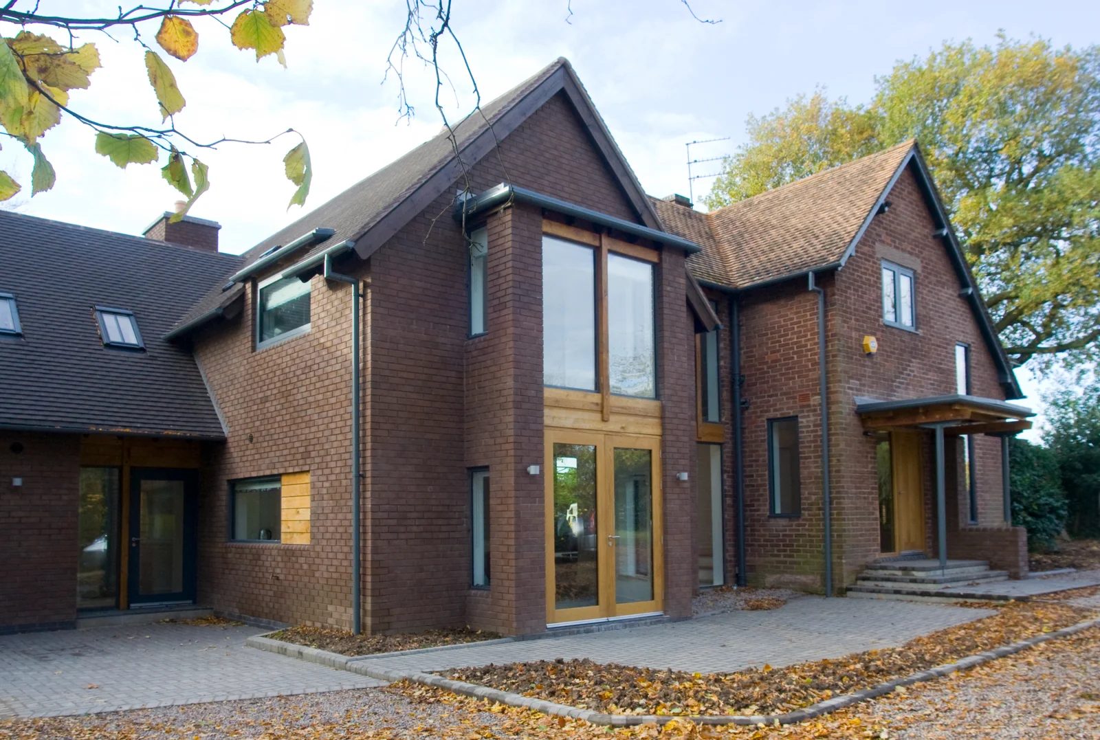Brick gables and full-height glazing at October House