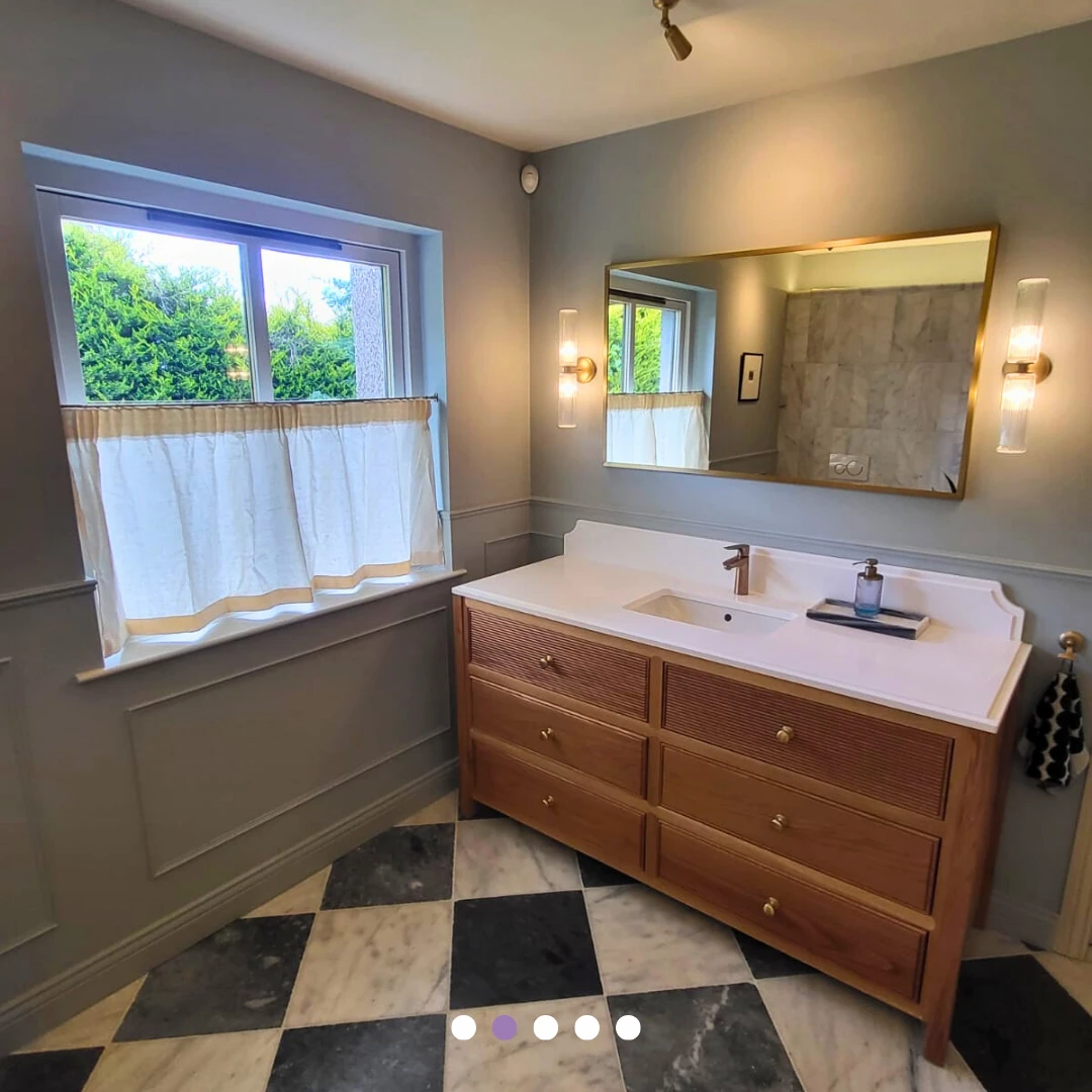 Timber vanity, brass-framed mirror and wall lights